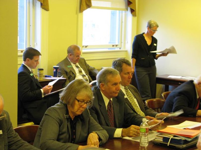 In the background are lobbyists Jason Kreizenbeck and Skip Smyser, who represent Corrections Corp. of America, as legislative budget writers review the corrections budget early Monday morning. (Betsy Russell)