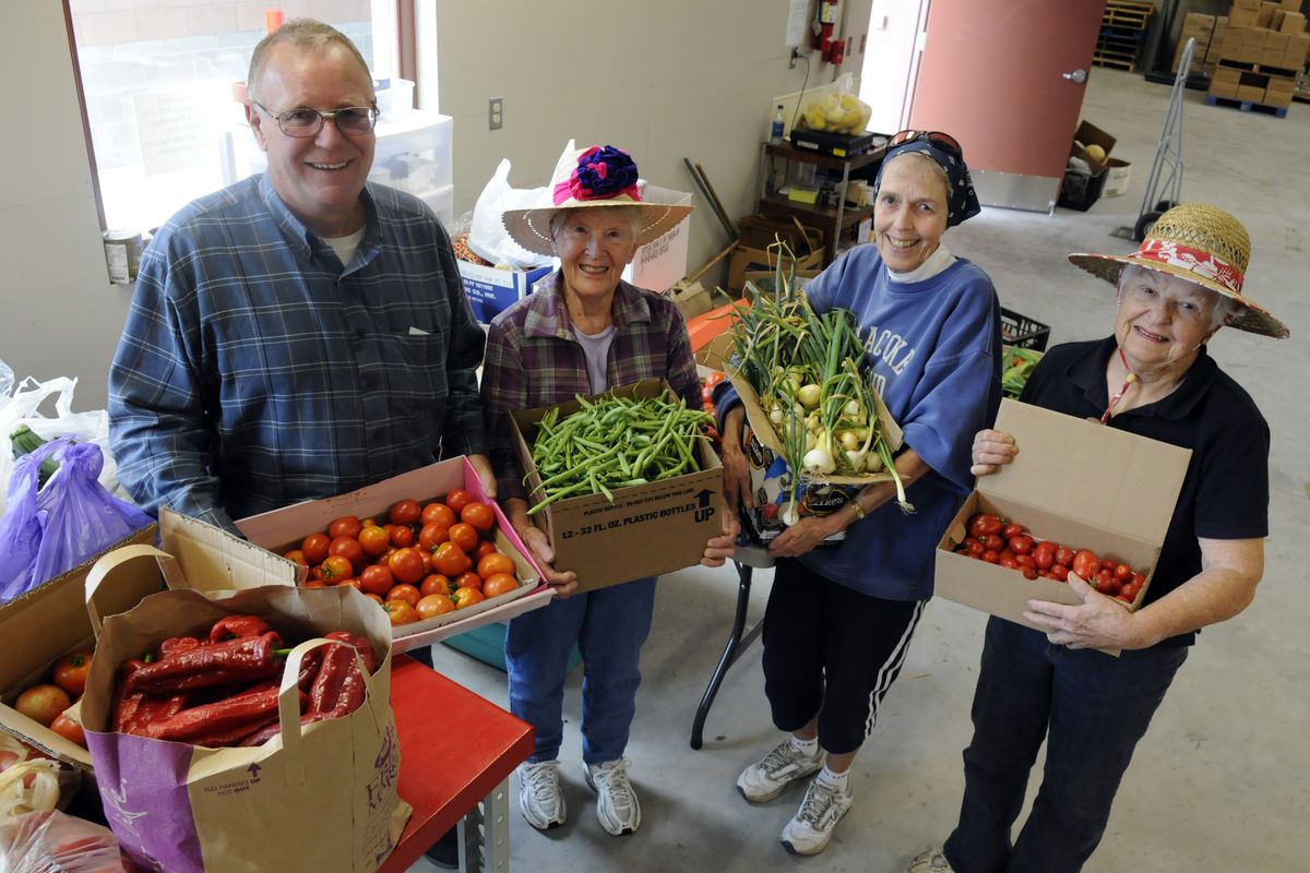 Veradale United Church of Christ members Glen Scott, Letia Hayward, Abby Byrne and Jeanne Koegen show off some the vegetables  they picked and delivered to the Spokane Valley Partners Food Bank warehouse on Sept. 8.bartr@spokesman.com (J. BART RAYNIAK / The Spokesman-Review)