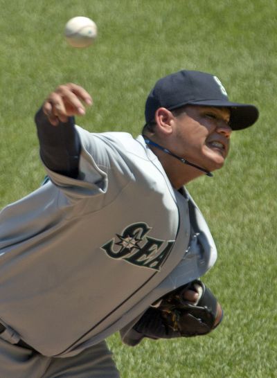 Seattle’s Felix Hernandez fires one of the 89 pitches he needed to pitch eight innings against Kansas City and earn his eighth win of the season. (Associated Press)