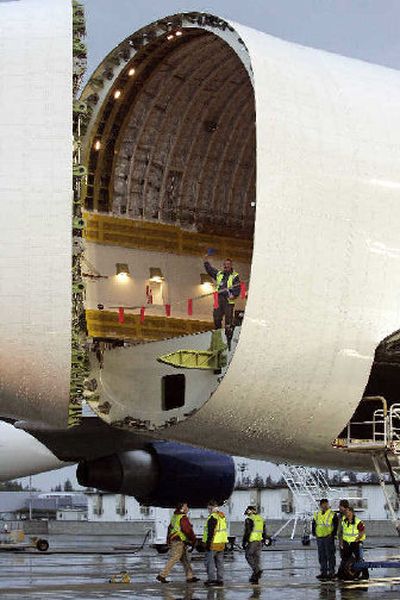
A worker waves from inside a Boeing 747 Dreamlifter, carrying the first major assembly for the Boeing 787 Dreamliner, after the rear of the plane was opened up on its arrival from Italy last week in Everett. 
 (Associated Press / The Spokesman-Review)