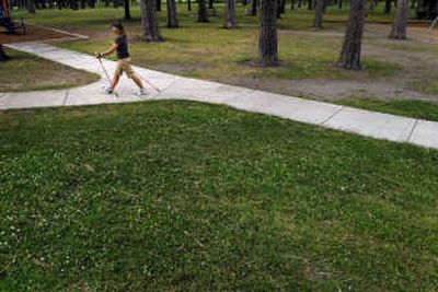 
Patti Jouppi walks Nordic style through Spokane's Audubon Park, where she teaches a walking class. 
 (Photos by Brian Plonka / The Spokesman-Review)