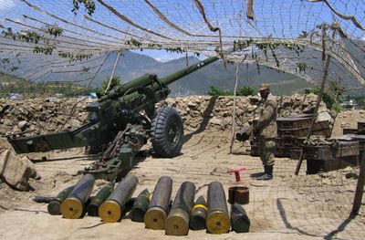 A Pakistani soldier is seen with heavy artillery at a post on the outskirts of Timargarh in the Pakistani district Lower Dir, where security forces launched an offensive  against militants on Tuesday. (Associated Press / The Spokesman-Review)