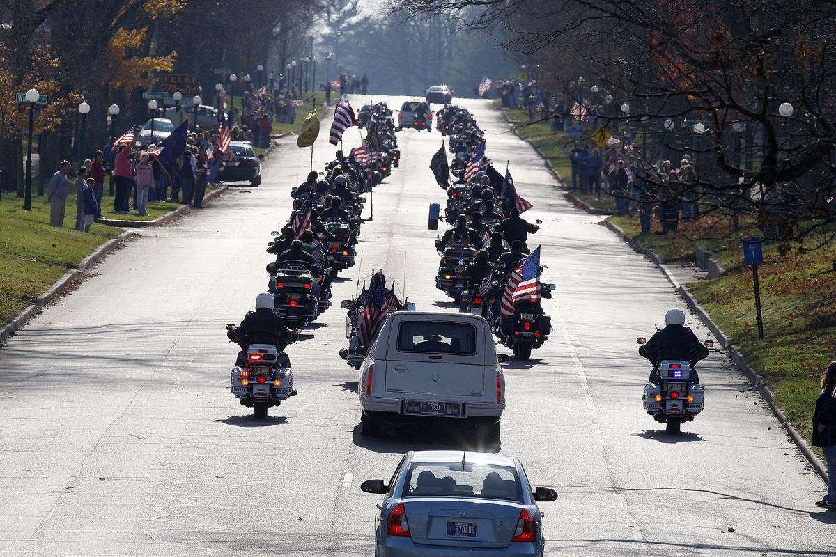 The funeral procession of Staff Sgt. Justin DeCrow makes its way through downtown Plymouth, Ind., on Saturday.  DeCrow was killed last week at Fort Hood, Texas. Associated Press photos (Associated Press photos)