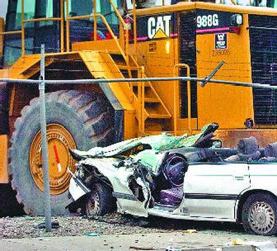 
The wreckage of a Subaru station wagon lies smashed against heavy construction equipment at the corner of Waterworks and Union early Wednesday morning. 
 (Christopher Anderson / The Spokesman-Review)