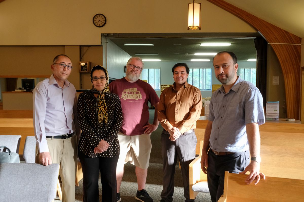 Mohammad Ahmadi, left, and his wife, Sorayya Mohammadi – both Hazaras refugees, a persecuted Shiite sect of Muslims – pose for a group photo with Steve Lympus, head pastor with Shadle Park Presbyterian Church, and Esmatullah Hashem and Sayed A. Hussaini in June in Spokane.  (Tyler Tjomsland/THE SPOKESMAN-REVIEW)