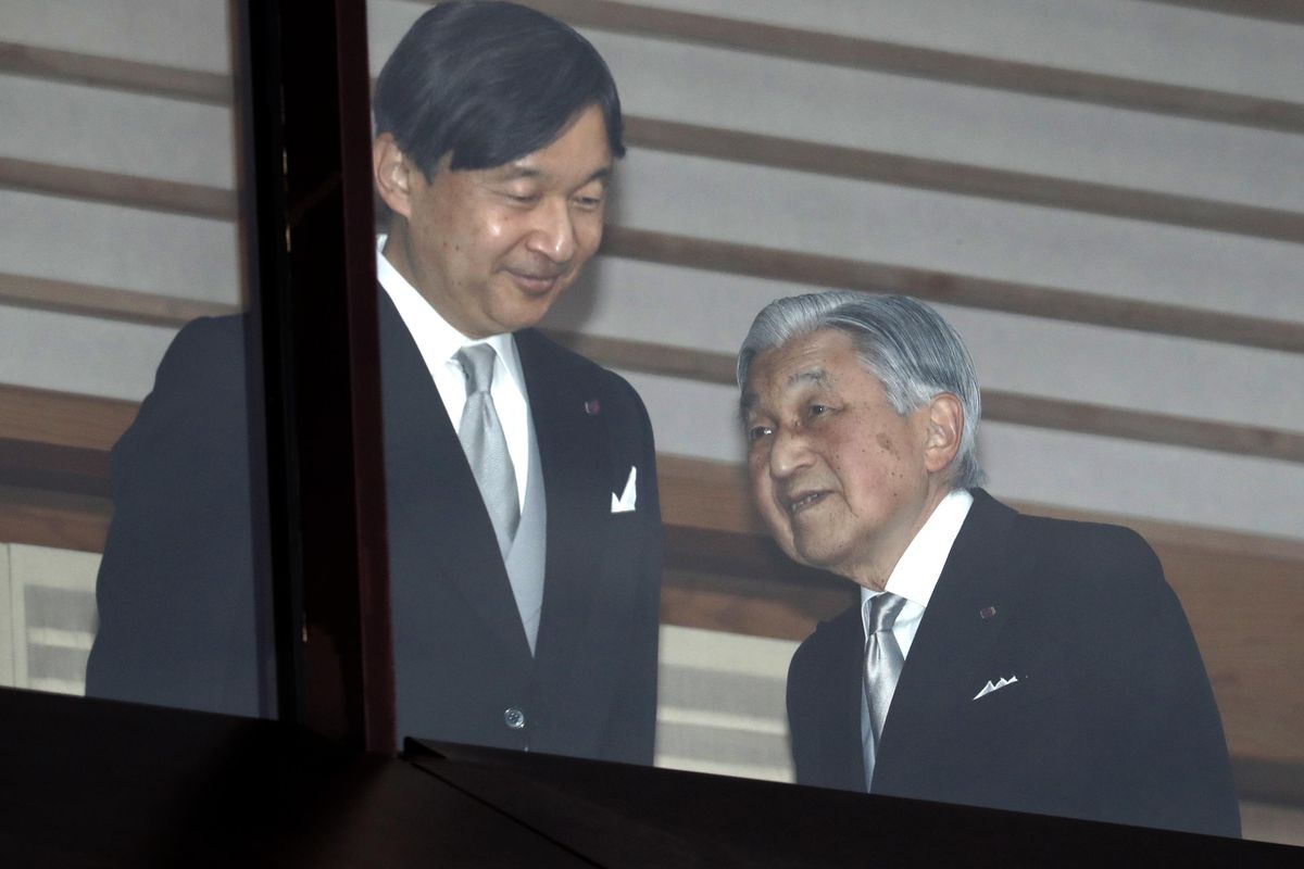 In this Dec. 23, 2018,  photo, Japan’s Emperor Akihito, right, accompanied by Crown Prince Naruhito, walks away after greeting well-wishers when they appeared on the balcony of the Imperial Palace to mark the emperor’s 85th birthday in Tokyo. (Eugene Hoshiko / AP)