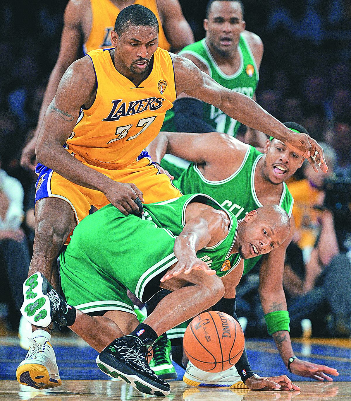 Celtics Ray Allen, front, and Paul Pierce scramble for the ball with Lakers’ Ron Artest during the first half. (Associated Press)
