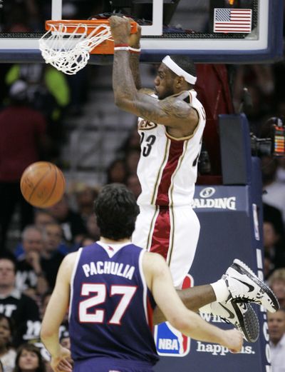 Cleveland’s LeBron James slams home two of his 34 points Tuesday.  (Associated Press / The Spokesman-Review)