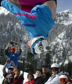 Don Brockett performs a flip on skis during a pond skimming event at Snoqualmie Pass, Wash., March 24, 2013. Traditionally, crowds start to thin in April as ski areas wind down their operations, but this can be one of the best months of the season. (AP Photo/Janet Jensen, The News Tribune) (Janet Jensen / Associated Press)
