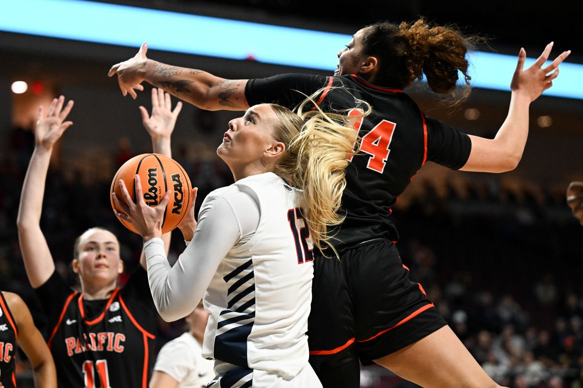 Gonzaga Bulldogs forward Eliza Hollingsworth (12) heads to the rim against Pacific Tigers center Elizabeth Elliott (14) during the second half of a WCC women’s semifinal basketball game on Monday in Las Vegas.  (Tyler Tjomsland/The Spokesman-Review)