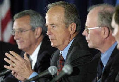 
Peter Ueberroth, seated between Ted Boehm and Bill Martin, right, speaks during a news conference on Monday. 
 (Associated Press / The Spokesman-Review)