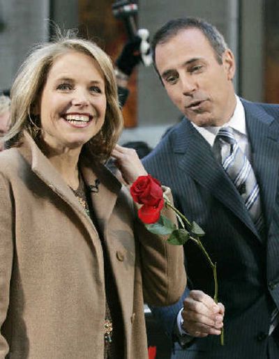 
Matt Lauer gives a rose tossed from the audience to his NBC 