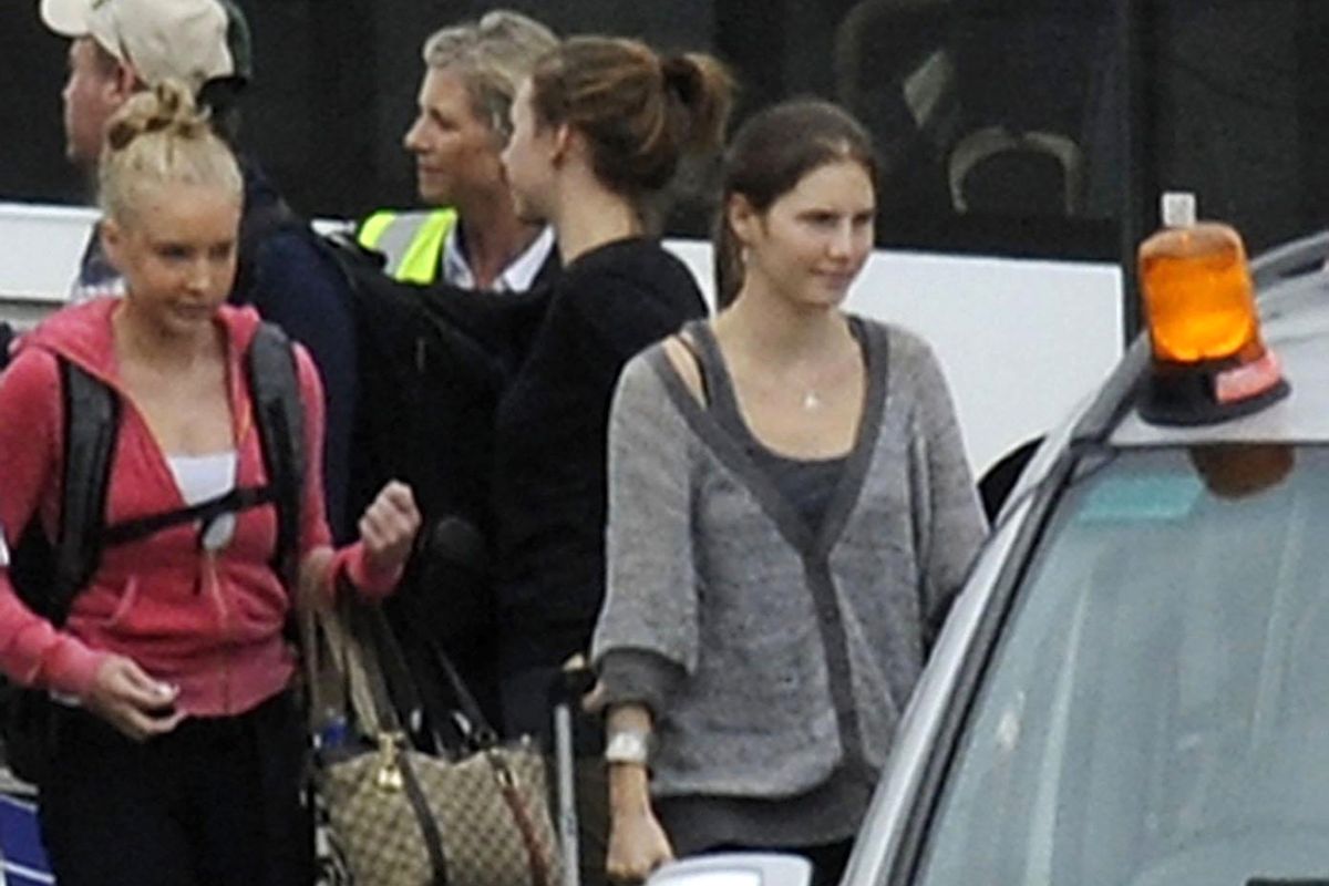 Amanda Knox, right, arrives from Rome with family members at Heathrow Airport London, Tuesday, Oct. 4, 2011. Amanda Knox headed home to the United States a free woman Tuesday, after an Italian appeals court dramatically overturned the American student