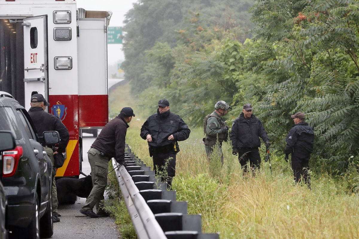 Police work in the area of an hours long standoff with a group of armed men that partially shut down interstate 95, Saturday, July 3, 2021, in Wakefield, Mass.  (Michael Dwyer)