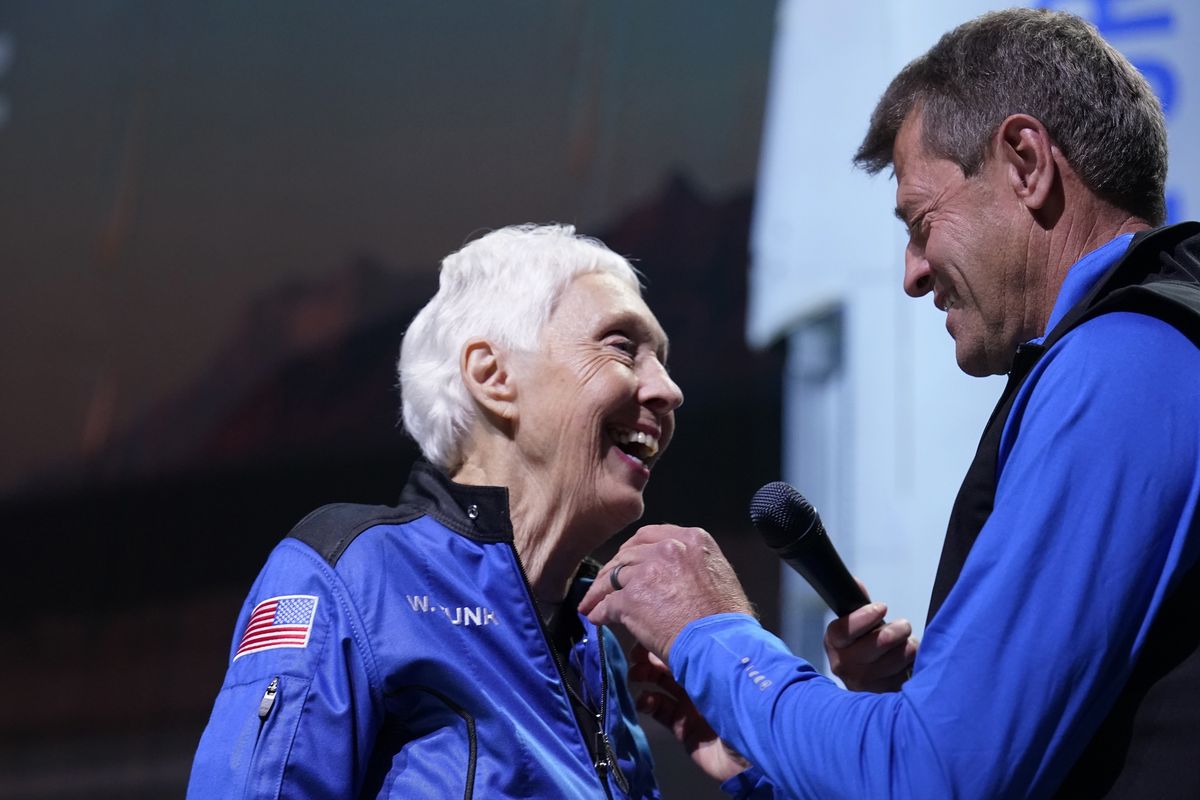 Wally Funk is awarded the Blue Origin-made astronaut wings by former NASA astronaut Jeff Ashby, who is now based with Blue Origin, during a New Shepard post-launch briefing at the spaceport near Van Horn, Texas, on Tuesday, July 20, 2021.  (Tony Gutierrez/Associated Press)