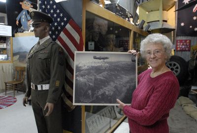 Lois Cunningham holds a photo taken by her late husband, Jack Cunningham, from his B-24 during World War II. She  was honored with the Spokane Valley Heritage Museum’s Heritage Preservation Award during the  tea and history party Nov. 8. She has volunteered at the museum since it opened in 2002 and has donated some of her late husband’s photographs to the museum.  (J. BART RAYNIAK / The Spokesman-Review)