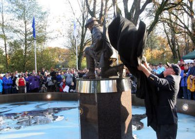 
Clay Kesterson unveils a statue during the dedication of the Afghan-Iraqi Freedom Memorial in Salem on Saturday. 
 (Associated Press / The Spokesman-Review)