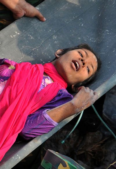 Reshma Begum is carried from the rubble of a building in Savar, Bangladesh, on Friday. (Associated Press)