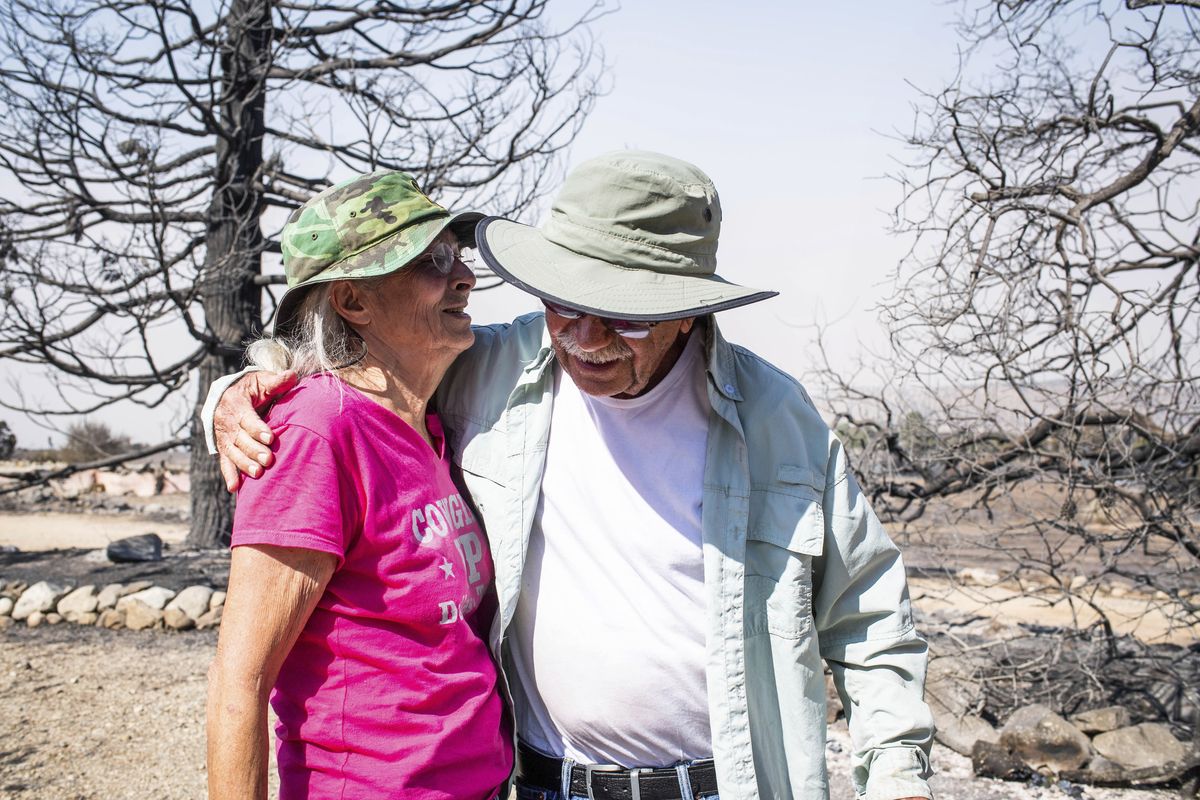 Robert Wise hugs on Monday, Sept. 21, 2020 his neighbor Cheryl Poindexter, who lost her home of 27 in the Bobcat fire. Poindexter ran an animal rescue on her 11 acres along Juniper Hills Road.  (Sarah Reingewirtz)