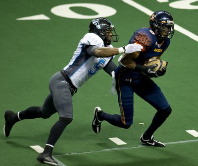 After Spokane Shock's Greg Orton hauls in a reception, Philapelphia's Chris Martin moves in for the tackle in the first half of their Arena Football League game, Friday, June 10, 2011, in the Spokane Arena.  (Colin Mulvany)