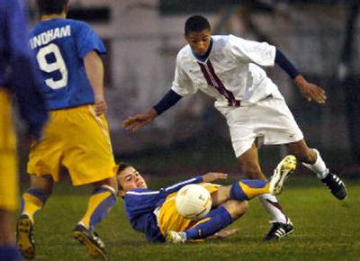 
University midfielder Michael Ramos, right, gets tripped up by Mead's Cameron Bushey. 
 (Holly Pickett / The Spokesman-Review)