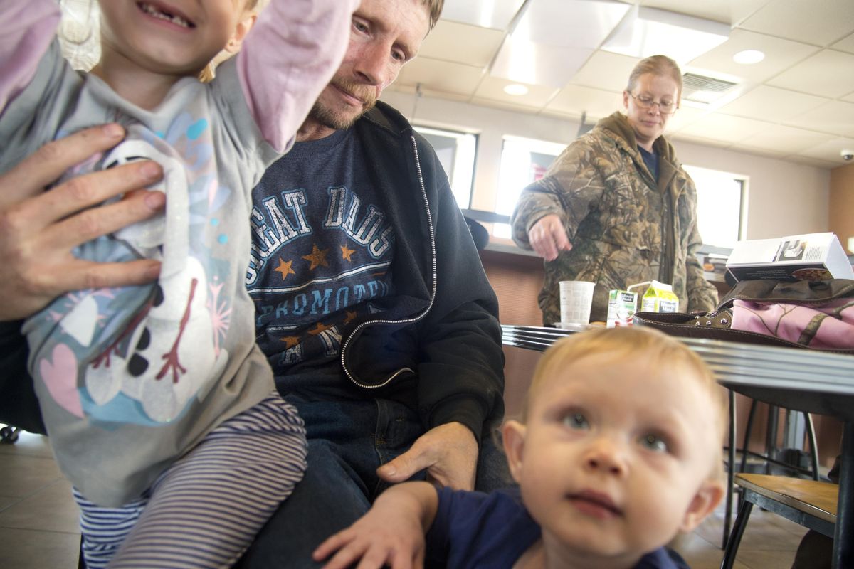Hal Whitcher holds onto two of his granddaughters, Savanna, 5 and Christine, 18 mos., while his wife Kayla clears their table at a Jack in the Box restaurant in downtown Spokane after lunch with some of their grandchildren, Monday, Oct. 24, 2016. The two were grandparents to 3-year-old Noah Whitcher, who died in a fire last weekend. The two girls are cousins to Noah. Hal Whitcher said that their family is wracked with every emotion imaginable at the loss of Noah. (Jesse Tinsley / The Spokesman-Review)