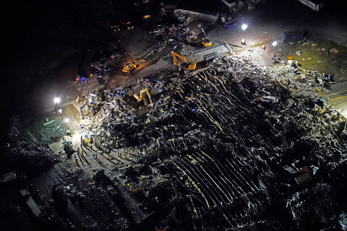 FILE-In this aerial file photo, a collapsed factory is seen with workers searching for survivors, after tornadoes came through the area the previous night, in Mayfield, Ky., Saturday, Dec. 11, 2021. Survivors of a tornado that leveled a Kentucky candle factory, killing eight workers, have filed a lawsuit claiming their employer demonstrated “flagrant indifference” by refusing to allow the employees to go home early.  (Gerald Herbert)