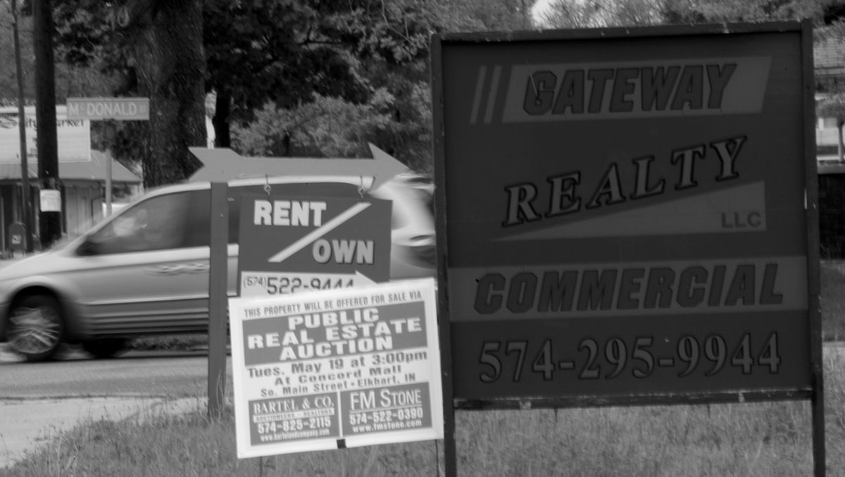 Several real estate signs reflect the housing and land market near downtown Elkhart, Ind. (Associated Press / The Spokesman-Review)