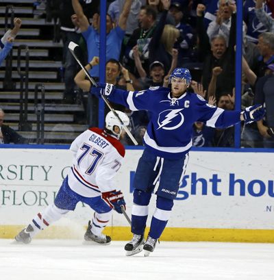 Tampa Bay's Steven Stamkos celebrates his goal in front of Montreal Canadiens' Tom Gilbert during the Lightnings’ 4-2 win. (Associated Press)