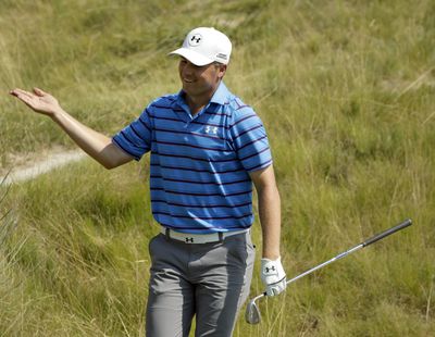 Jordan Spieth reacts after making bunker shot on the 18th hole. (Associated Press)