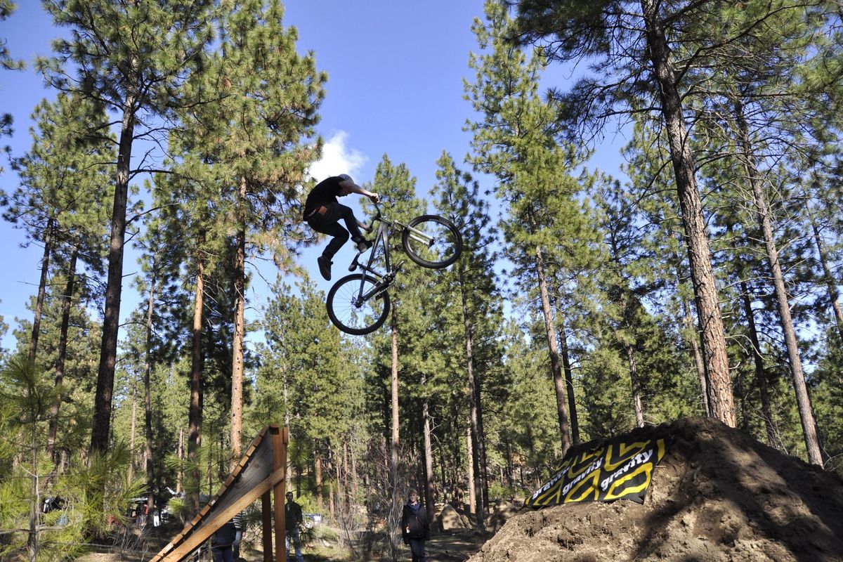 A bicyclist gets big air on the jumps course at Camp Sekani. (Rich Landers / The Spokesman-Review)