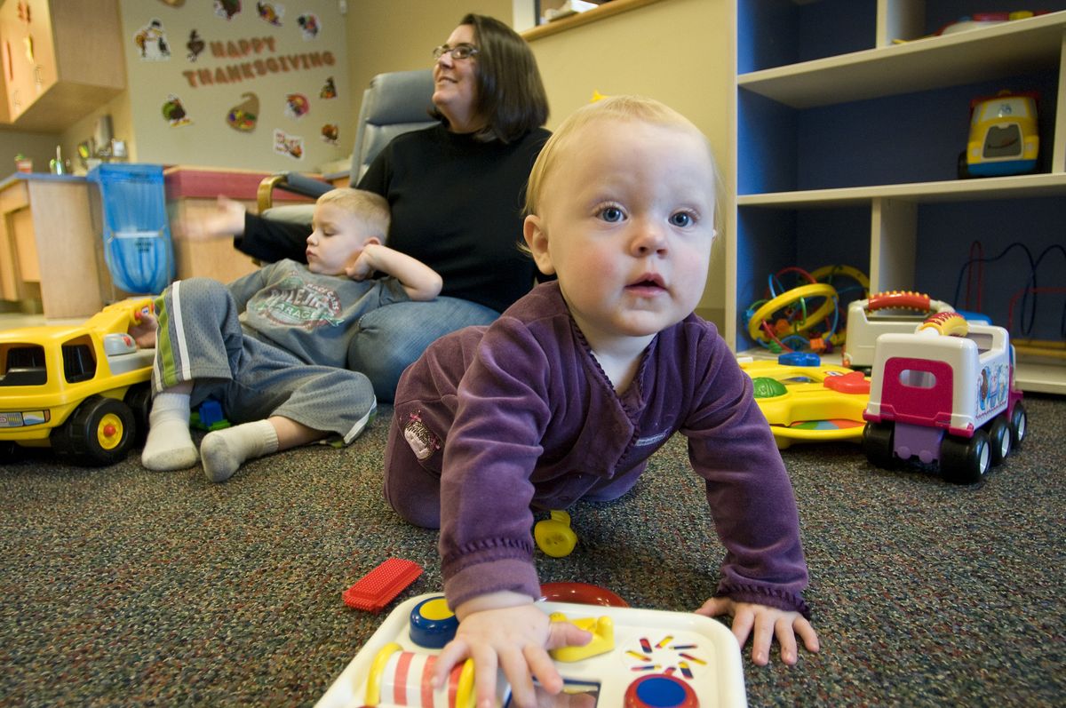 Cuddles & Care day-care worker Joy Kessinger spends time with sick kids, Ty Webb and Grace Obergh. Cuddles & Care, sponsored by Sacred Heart Medical Center, is the only place in town where you can bring sick children for day care.  (Photos by Colin Mulvany / The Spokesman-Review)