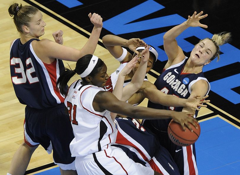 The bodies collide under the basket as Kelly Bowen of Gonzaga, right, and Kayla Standish, far left, battle the Louisville post players during the first half. (Christopher Anderson)