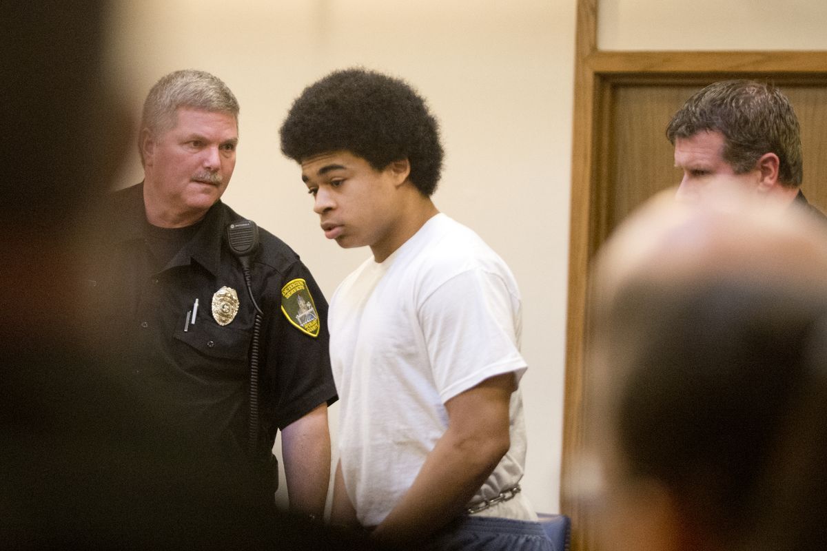 Kenan Adams Kinard, center, is led into a courtroom Wednesday, Jan. 7, 2015 before taking a plea dea in the murder of Delbert Belton. (Jesse Tinsley / The Spokesman-Review)