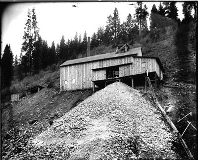 This 1905 photo of the Evolution Mine shows the head frame over the shaft, also known as the gallows. The shaft today is neither marked nor fenced.