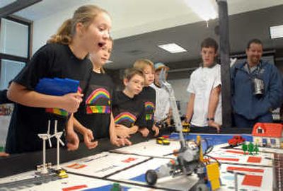 
From left, Kailey Arnone, Danielle Collinson, Devan Newton and Blake Livingston of the Sour Skittles team watch anxiously as their robot, built with parts from LEGO, performs a maneuver during practice time Saturday at River City Middle School in Post Falls. 
 (Jesse Tinsley / The Spokesman-Review)