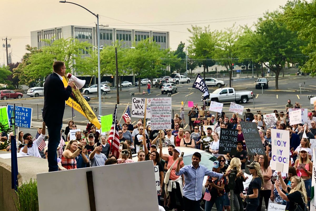 Matt Shea call masks tyranny as he addresses about 1,000 protesters outside the Spokane Regional Health District Friday.  (Colin Mulvany)