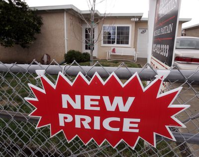 A reduced price sign is shown at a house in Pittsburg, Calif. A widely watched index shows home prices tumbled by the sharpest annual rate on record in the fourth quarter and in December.  (Associated Press / The Spokesman-Review)