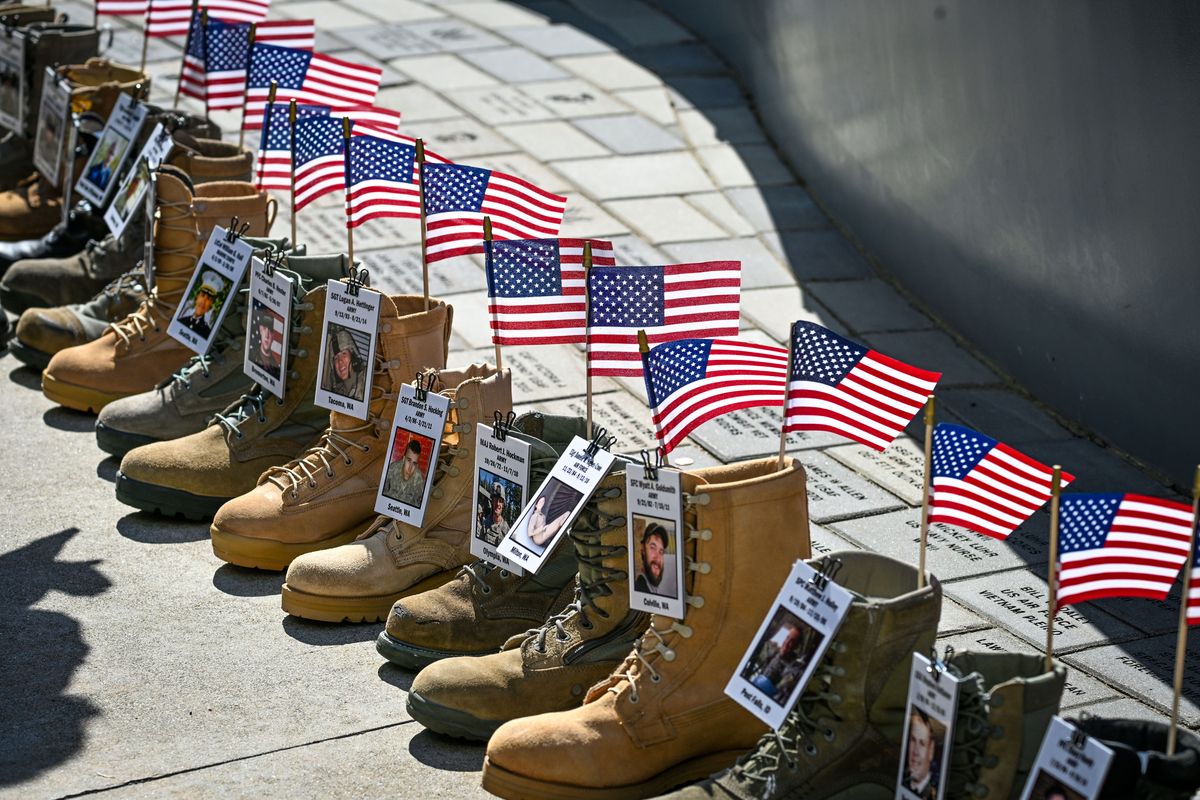 Washington State Fallen Heroes Project honored 250 fallen military members with a display of boots at the Illuminating Courage Memorial on Monday outside the Spokane Veterans Memorial Arena.  (DAN PELLE/THE SPOKESMAN-REVIEW)