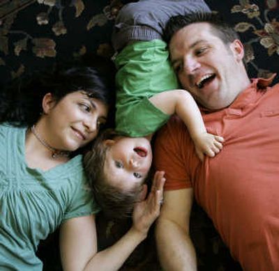 Between his parents, Michele and Greg, a two-year-old plays in San Francisco. None of the four boys in Michele Quiroga's 2005 birthing class in San Francisco were circumcised. Quiroga, the first person in her Jewish family to not circumcise a male offspring, prefers to say that her 23-month-old, pictured here, is 