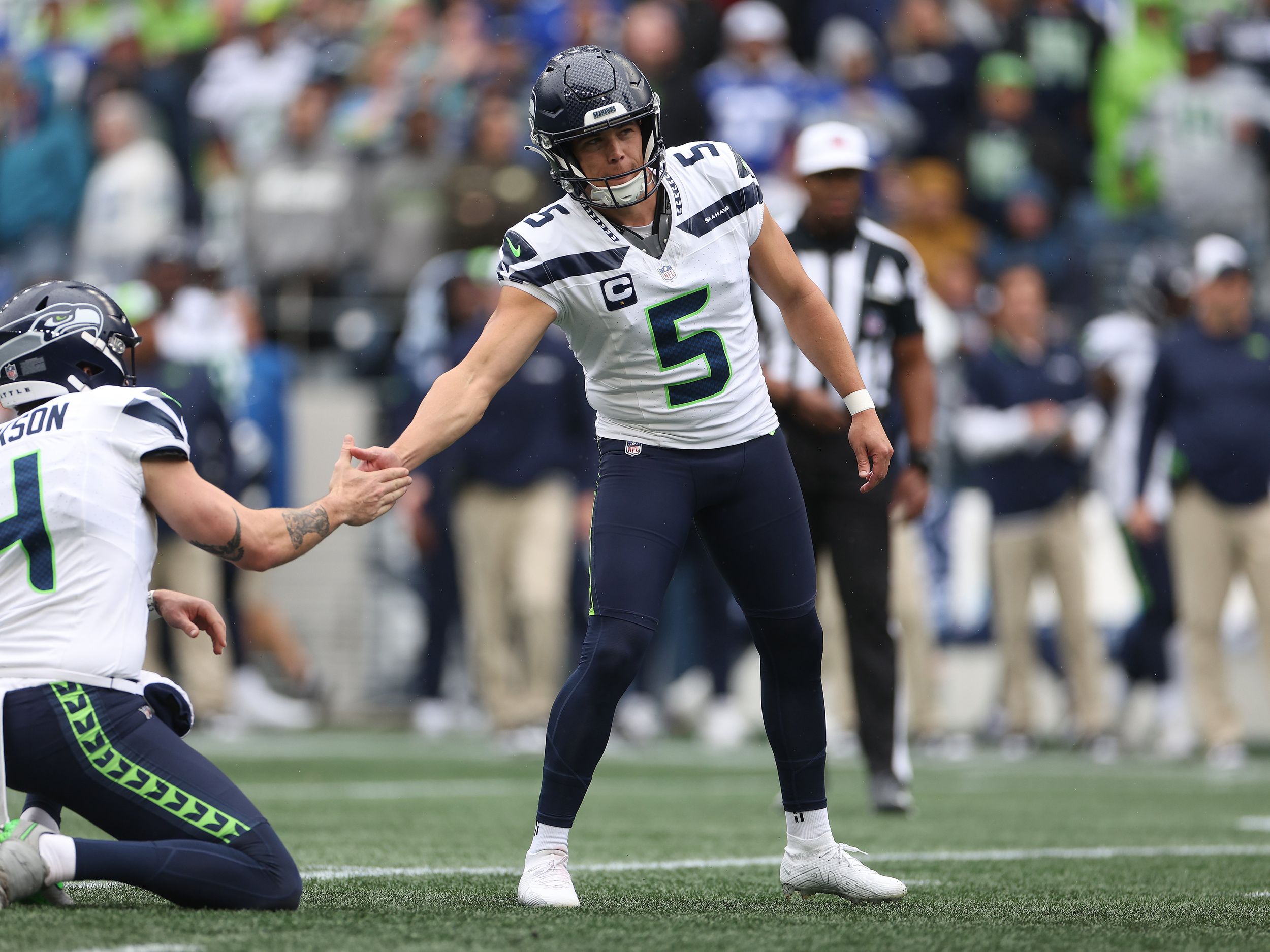 Seattle Seahawks place kicker Jason Myers (5) runs down the field