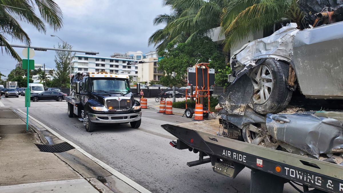 Vehicles that were pulled from the rubble of the Champlain Towers South are transported on Saturday, July 10, 2021 in Surfside, Fla. Surfside Mayor Charles Burkett said crews were making good progress, especially in clearing debris from the section of the building that didn’t collapse but was later demolished. That section will likely be cleared sooner than originally expected, he said.  (David Fischer)