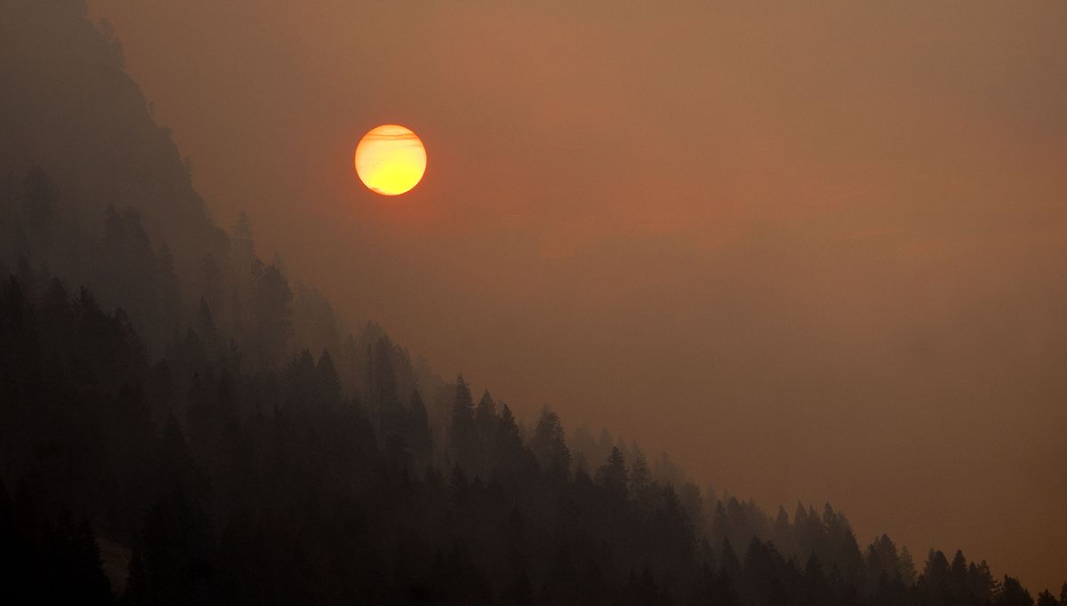 The sun burns through smoke over Bayview on Tuesday as crews work through the night to try to contain the fire that started Sunday. (Kathy Plonka)