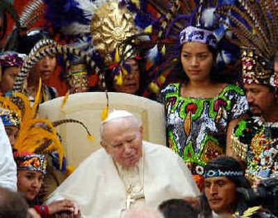 
Pope John Paul II is surrounded by pilgrims from Mexico and Guatemala in traditional clothing at the end of his general audience in this 2002 photo. 
 (File/Associated Press / The Spokesman-Review)