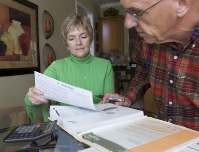 Judy and Bob Dienell review their financial statements in Braselton, Ga.  (Associated Press / The Spokesman-Review)