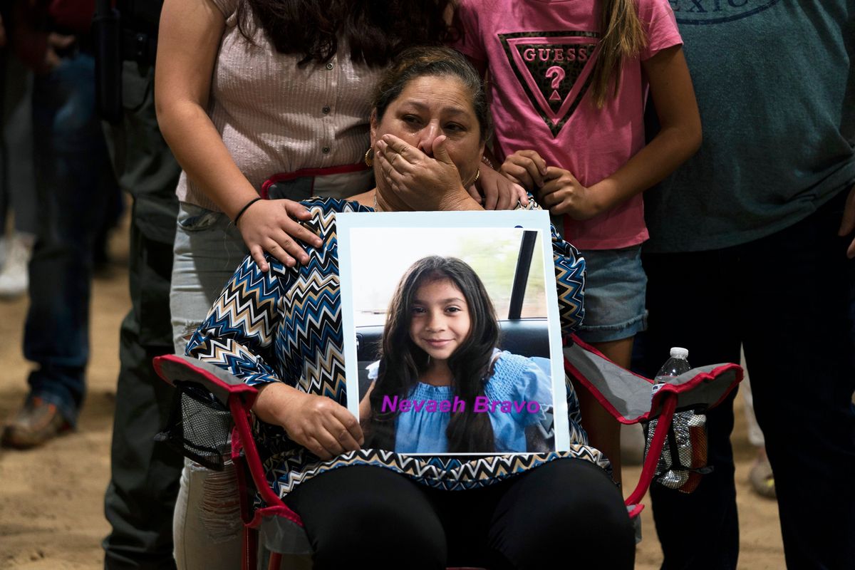 Esmeralda Bravo, 63, sheds tears while holding a photo of her granddaughter, Nevaeh, one of the Robb Elementary School shooting victims, during a prayer vigil in Uvalde, Texas, May 25, 2022. The children who survived the attack, which killed 19 schoolchildren and two teachers, described a festive, end-of-the-school-year day that quickly turned to terror.  (Jae C. Hong)