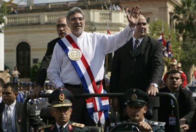 Paraguay’s President Fernando Lugo waves to supporters after his inauguration ceremony Friday.  (Associated Press / The Spokesman-Review)