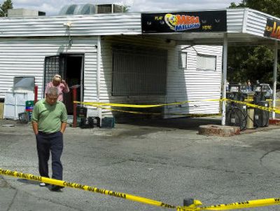 
Chin Cho walks away from the burned store Sunday afternoon after checking to see if anything had been taken. 
 (The Spokesman-Review)