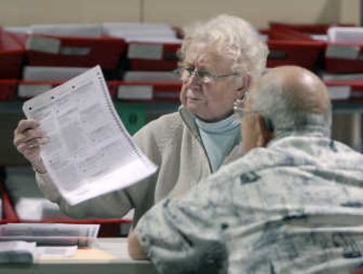 
Spokane County election workers Lillian Schillberg and Danny Petruss inspect mailed ballots for crossouts and write-ins.
 (Dan Pelle / The Spokesman-Review)