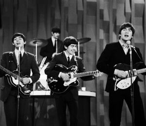 FILE - In this Feb. 9, 1964 file photo, The Beatles , from left, Paul McCartney, Ringo Starr on drums, George Harrison and John Lennon, perform on the CBS "Ed Sullivan Show" in New York.  The Beatles made their first appearance on "The Ed Sullivan Show," America's must-see weekly variety show, on Sunday, Feb. 9, 1964. And officially kicked off Beatlemania. (Dan Grossi / Associated Press)